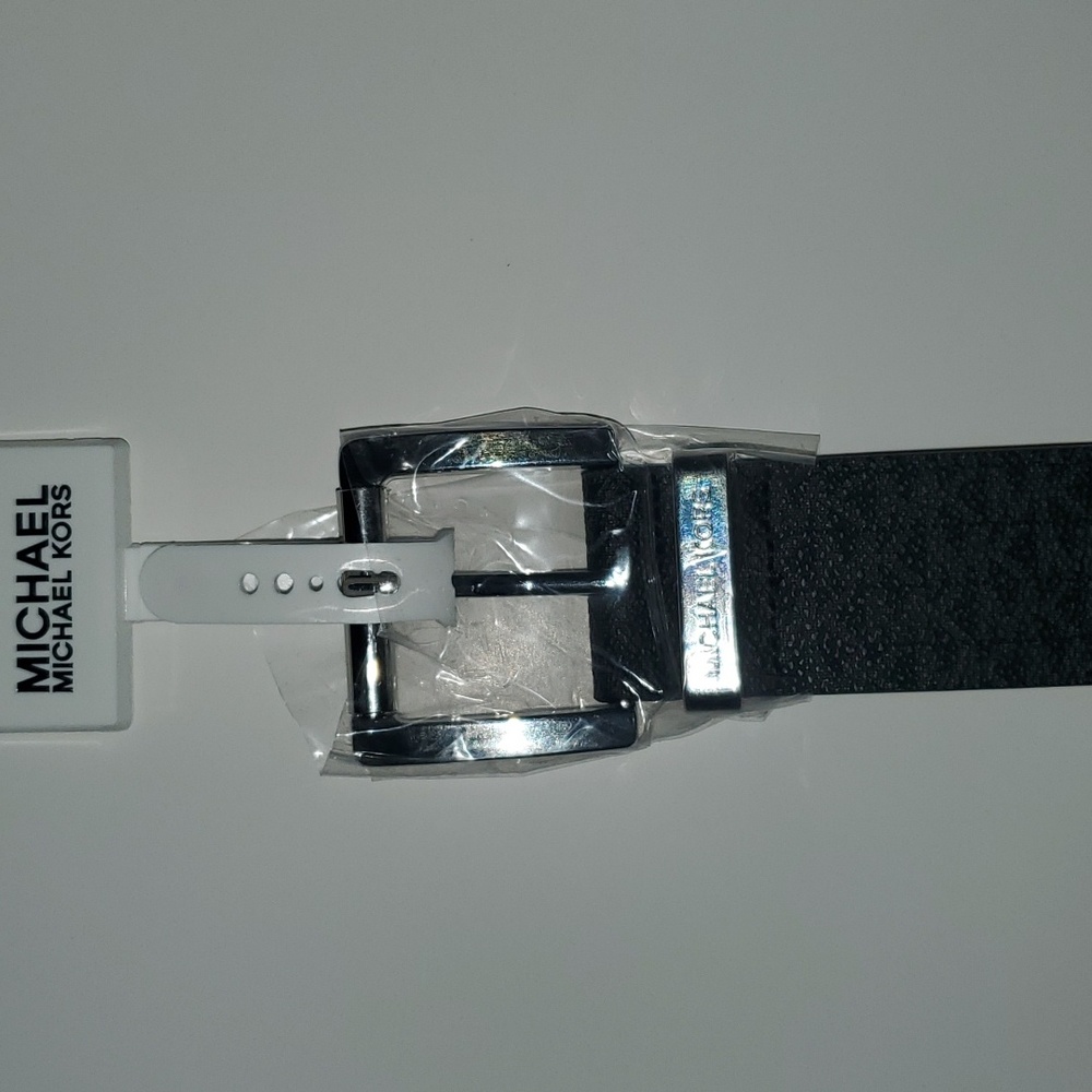 black michael kors strap with dark gray initials ( MK ) size M.